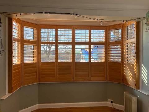 Wood shutters measured up in a bay window